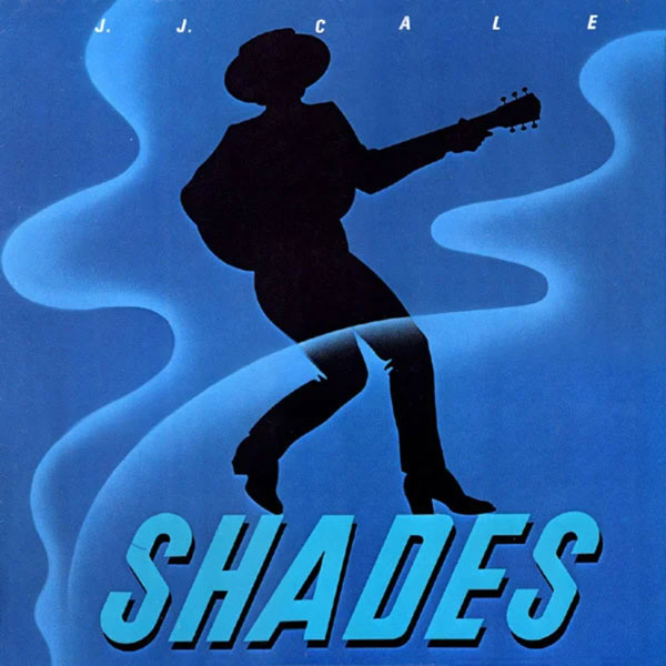 Cover des Albums Shades. Die schwarze Silhouette eines Gitarre spielenden Musikers mit Hut. Darüber Schaden von Zigarettenrauch und der Titel des Albums darunter. Das Cover erinnert an die Zigarettenpackung der französischen Marke Gitanes